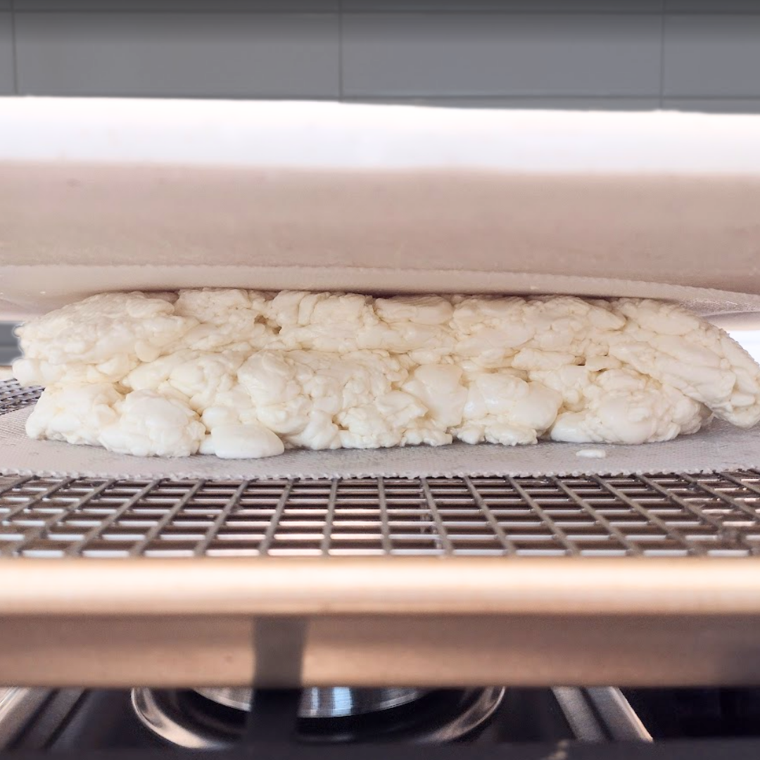 Pressing poutine curd